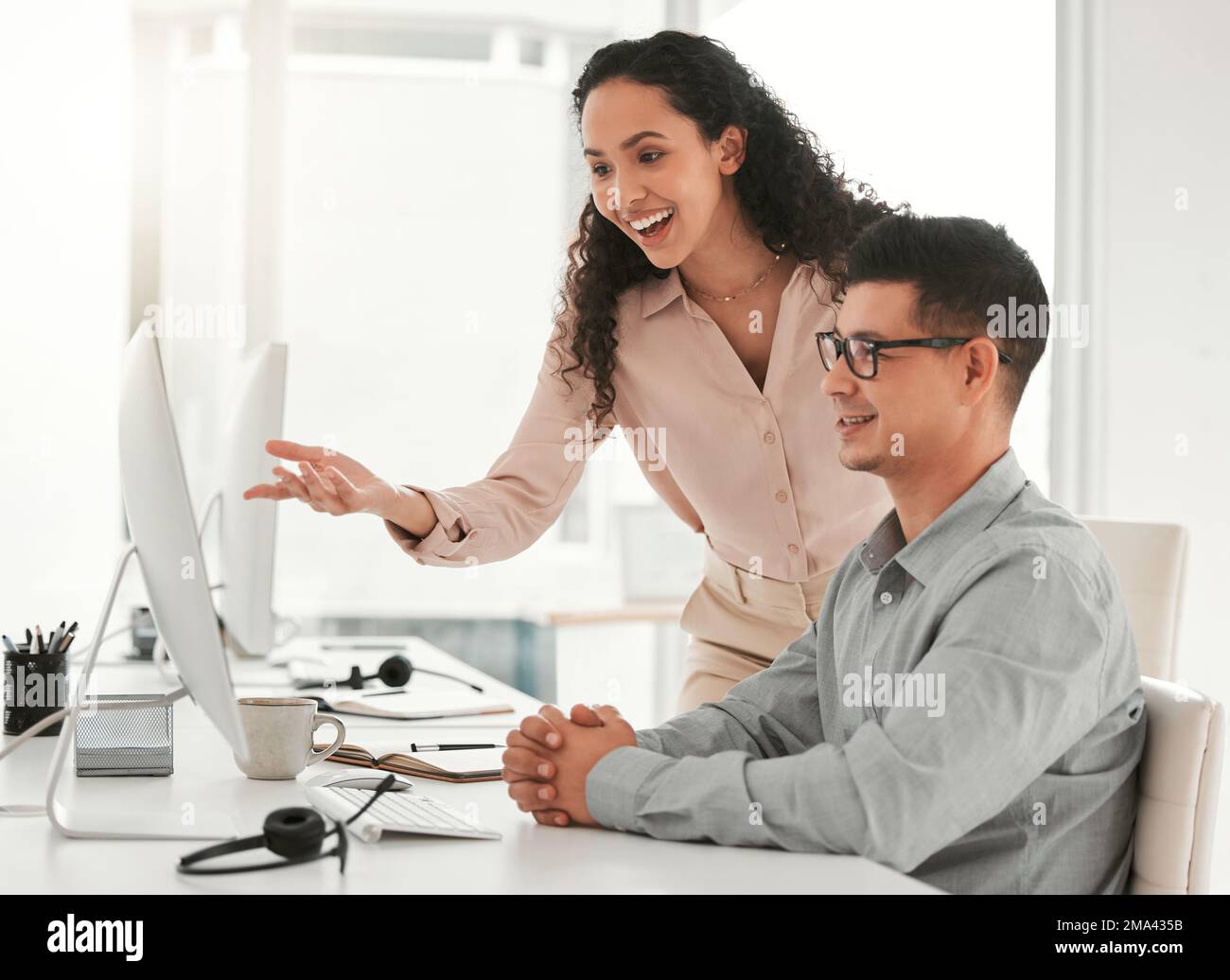Dont be scared to ask for help. two young colleagues using a computer