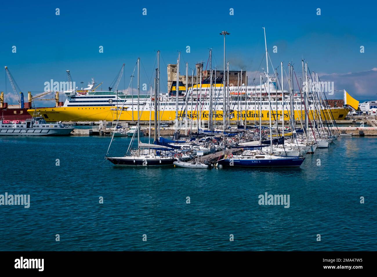 The Corsica Victoria, a Corsica Ferries ferry, is anchored in the Darsena part of the Port of Livorno, Porto di Livorno, surrounded by sailboats. Stock Photo