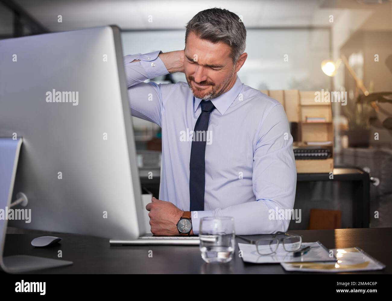 Its been a stressful day. a businessman suffering with neck pain while