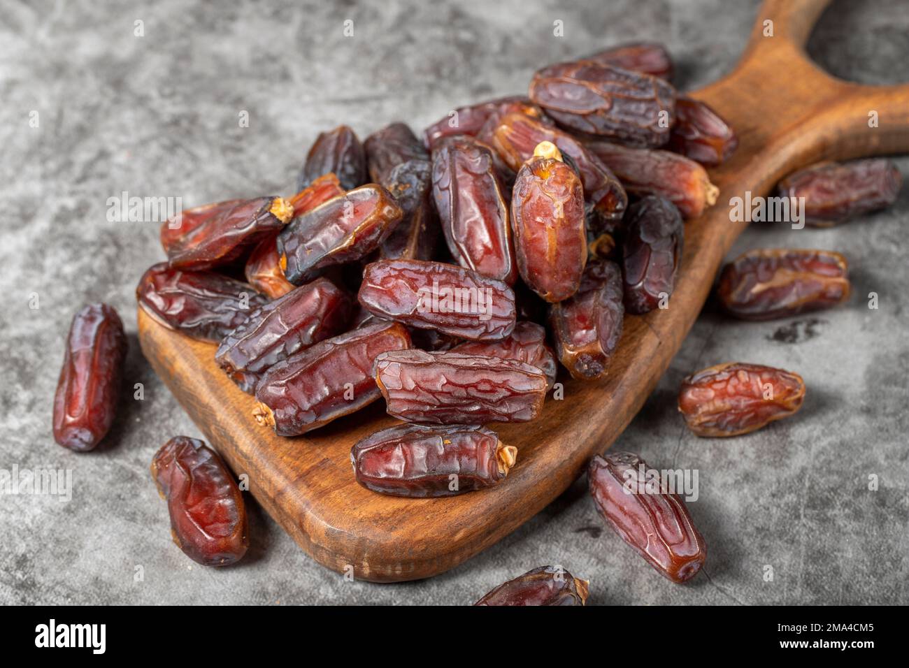 Date fruit on a dark background. Organic pile of medjoul dates on a