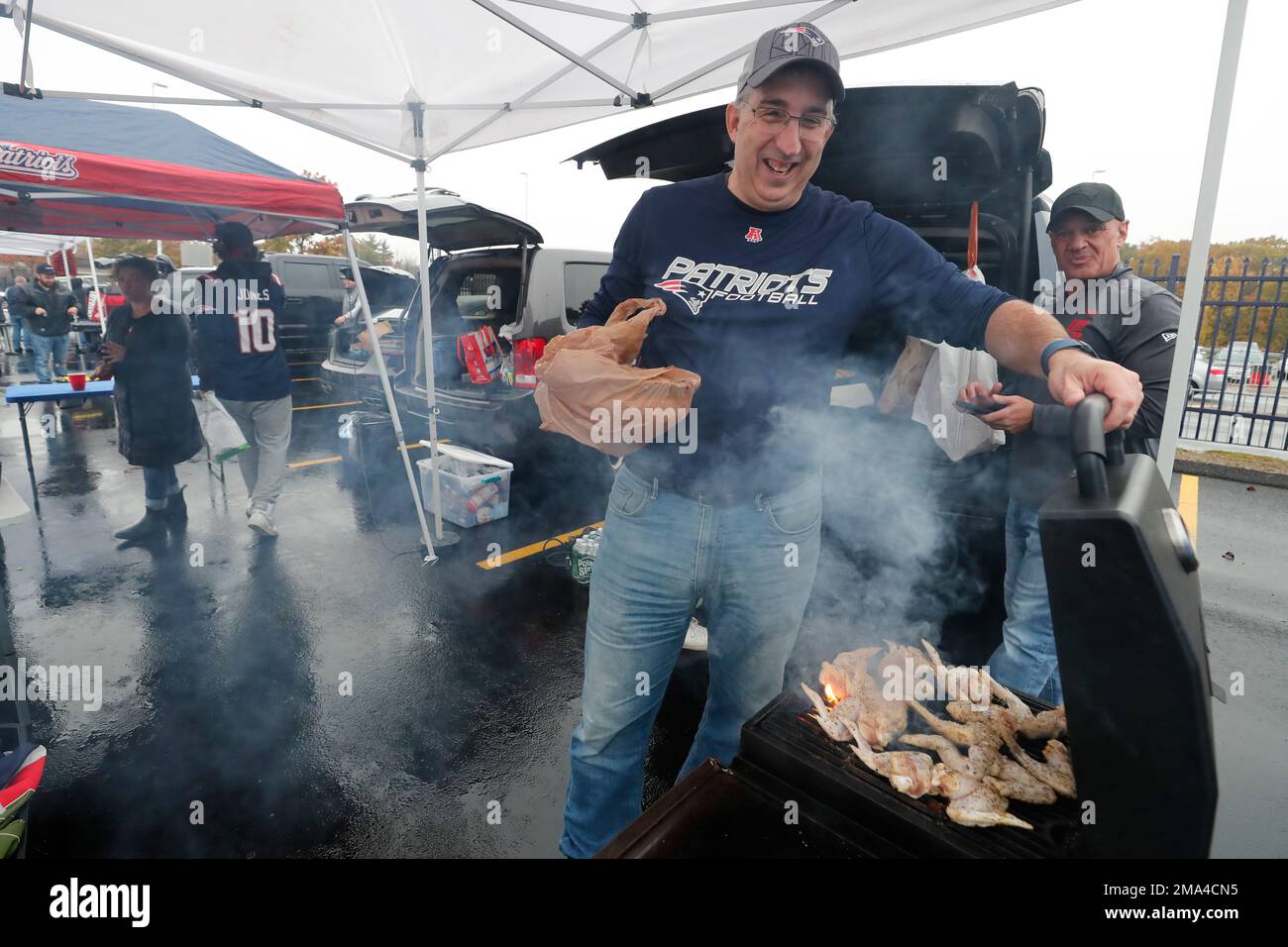 Fans tailgate in the parking lot of Gillette Stadium prior to an NFL