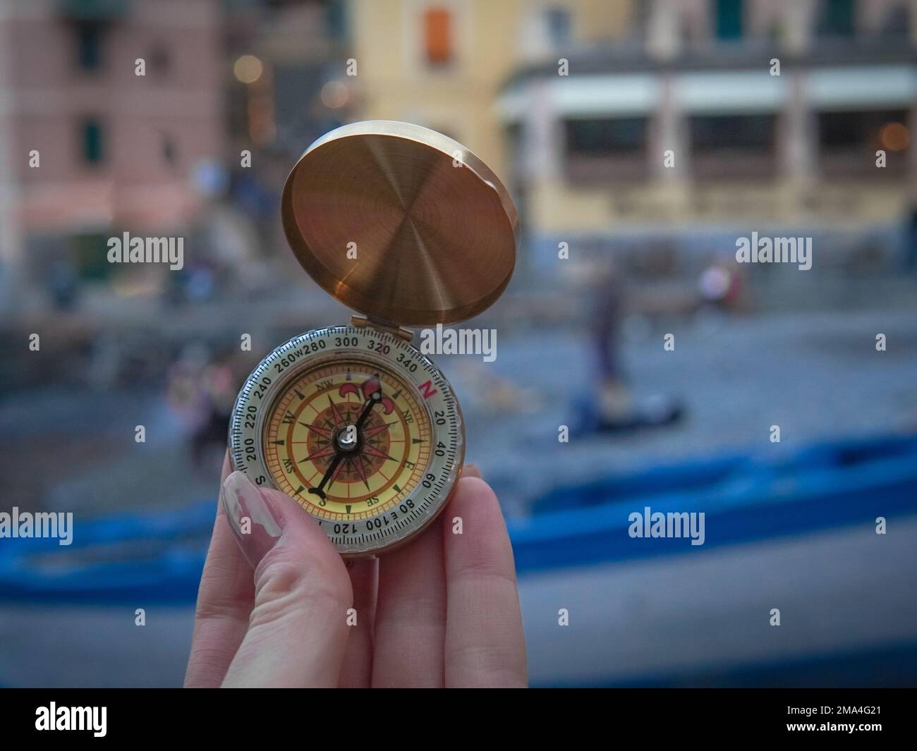close up of golden compass in hand,streetb background Stock Photo - Alamy