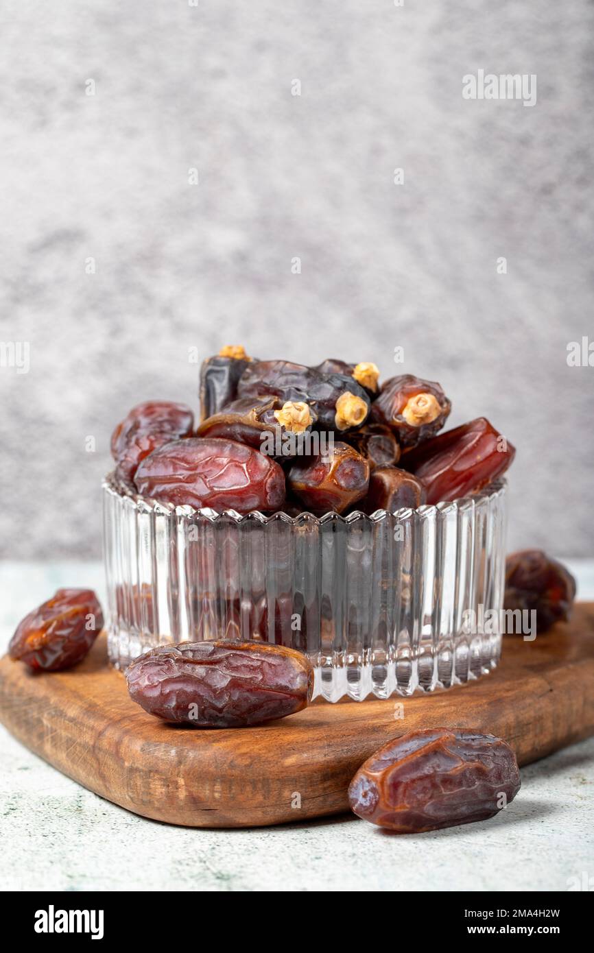 Date fruit on stone background. Organic Medjoul dates in a glass bowl. Ramadan food. close up Stock Photo