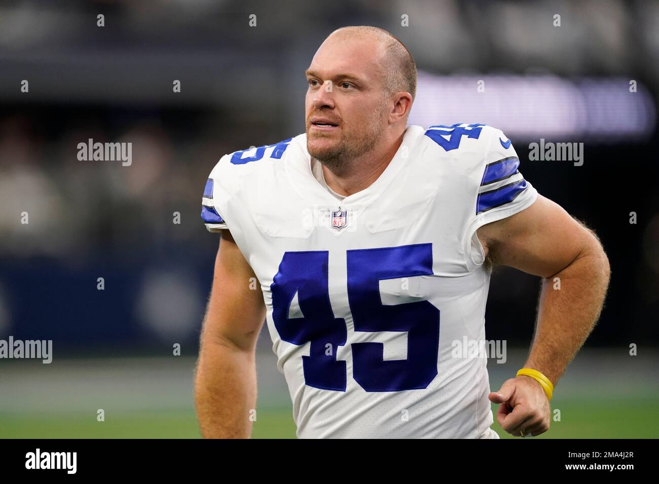 Dallas Cowboys long snapper Matt Overton jogs off the field after an