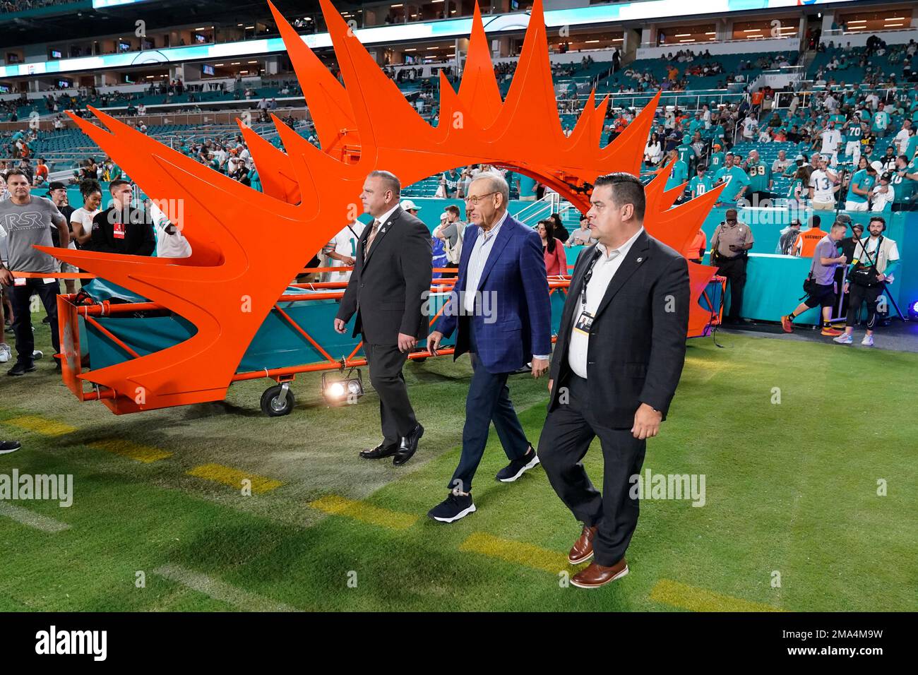 Miami Dolphins owner Stephen Ross, center, enters the field before an