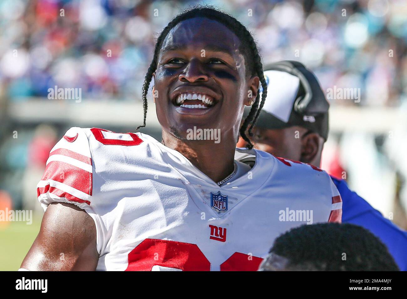 New York Giants cornerback Darnay Holmes (30) talks with teammates on the  sideline during an NFL