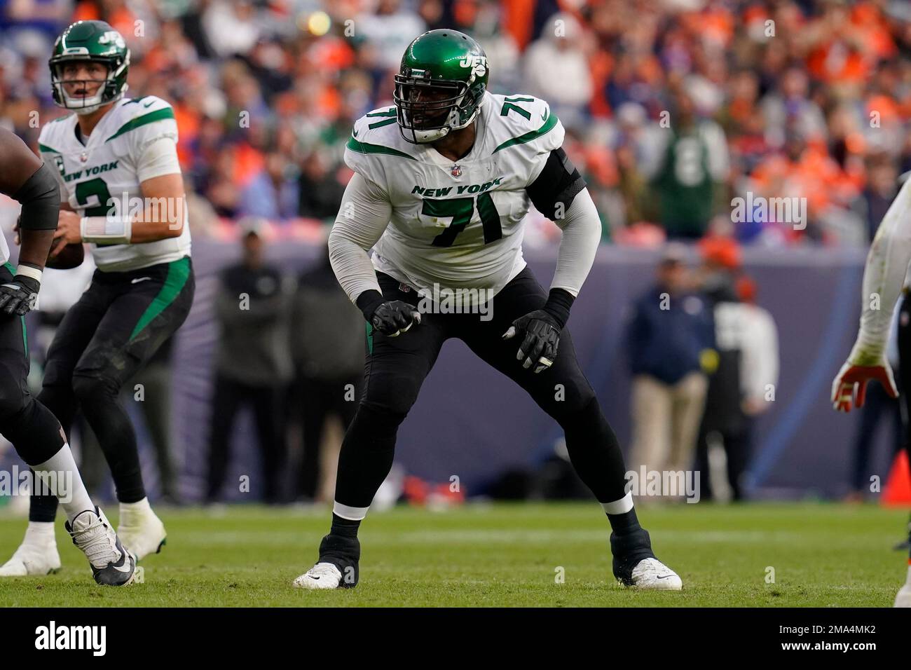 New York Jets offensive tackle Duane Brown (71) works against the Denver  Broncos during the second half of an NFL football game, Sunday, Oct. 23,  2022, in Denver. (AP Photo/Matt York Stock