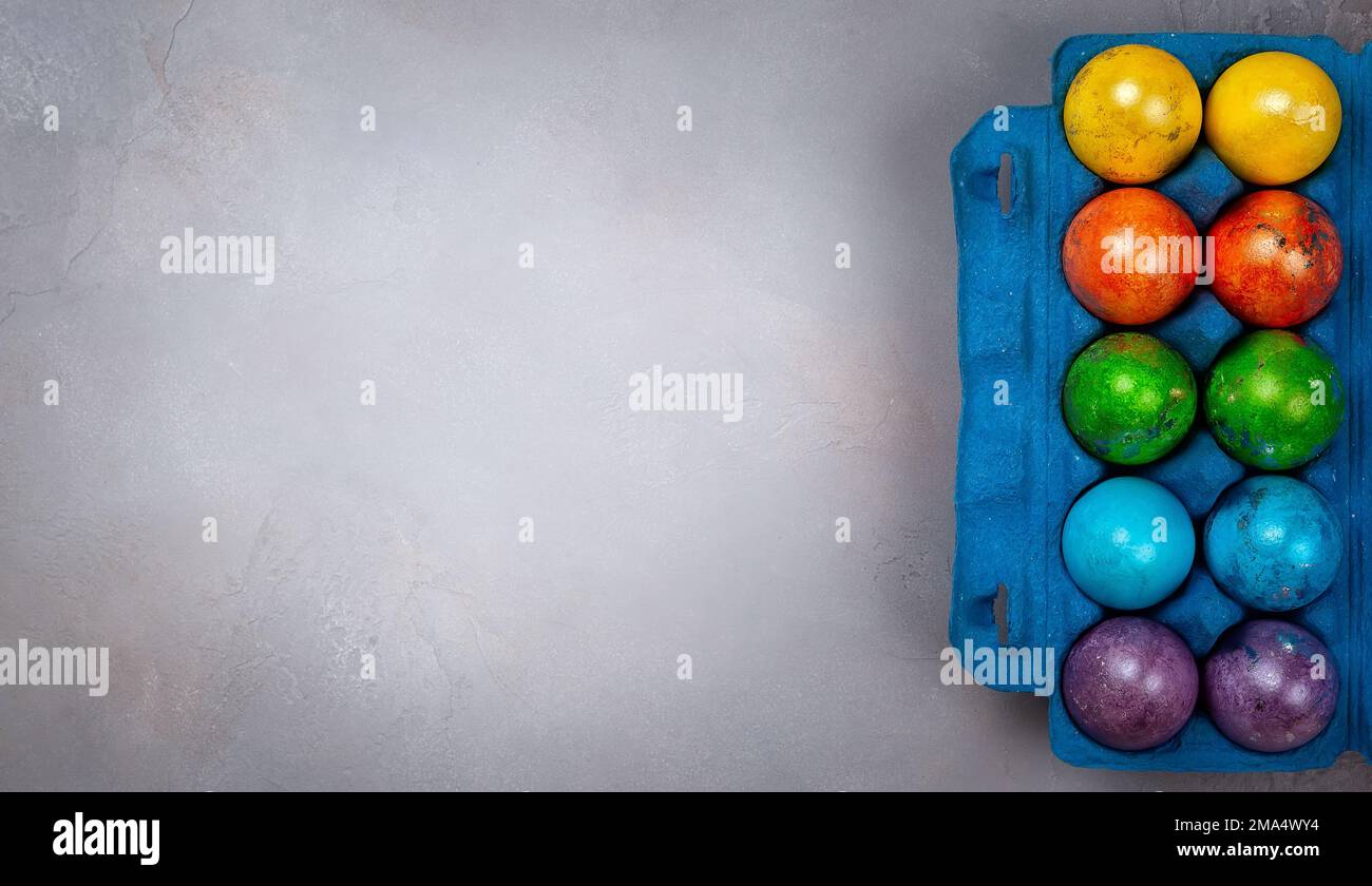 Easter concept wit colorful Easter eggs on grey background. Top view with copy space. Stock Photo