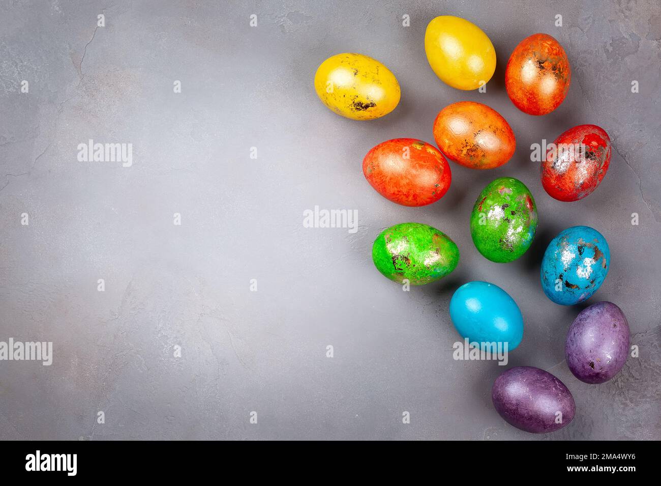 Easter concept wit colorful Easter eggs on grey background. Top view with copy space. Stock Photo