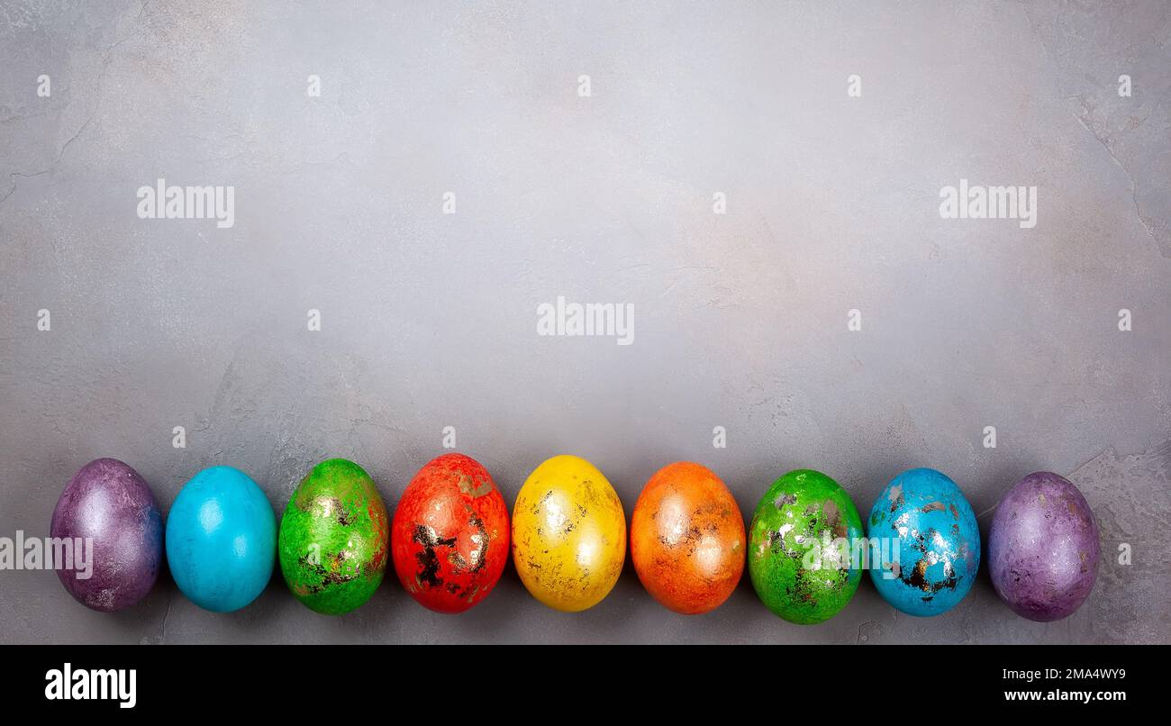 Easter concept wit colorful Easter eggs on grey background. Top view with copy space. Stock Photo