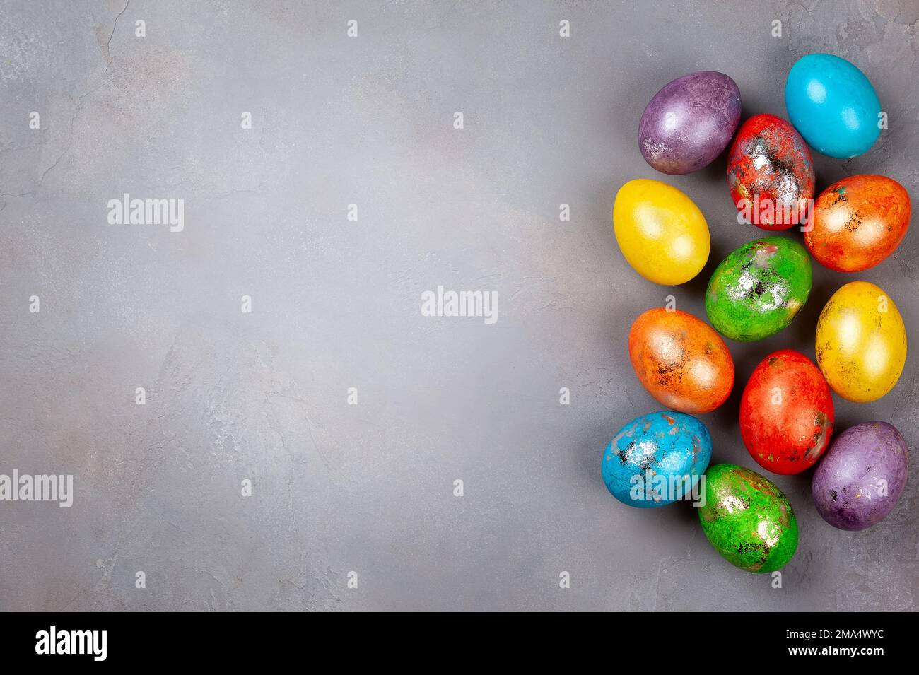 Easter concept wit colorful Easter eggs on grey background. Top view with copy space. Stock Photo