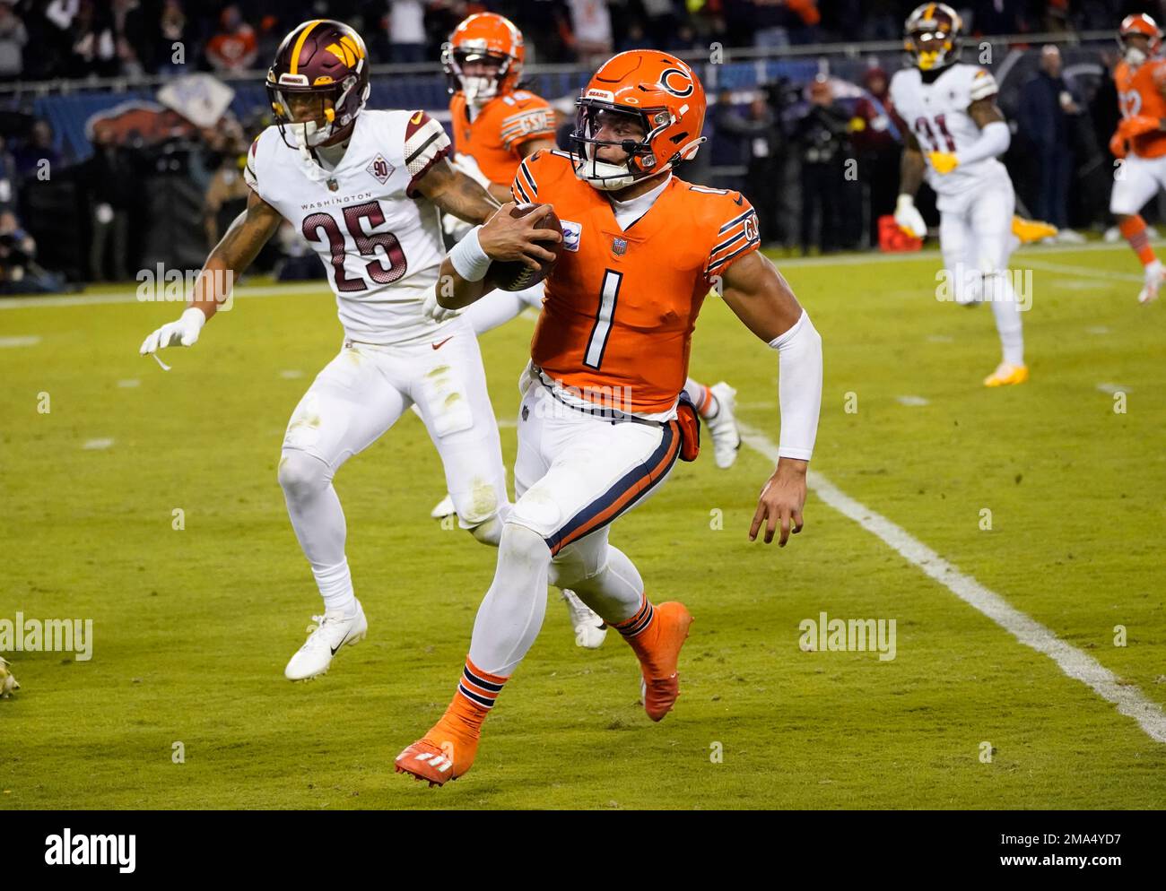 Chicago Bears quarterback Justin Fields carries the ball during an