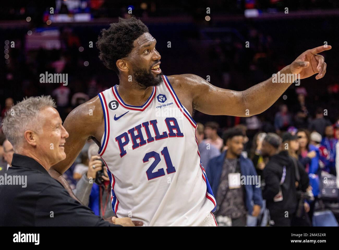Philadelphia 76ers center Joel Embiid (21) talks with San Antonio Spurs assistant  coach and former 76ers head coach Brett Brown after an NBA basketball game,  Saturday, Oct. 22, 2022, in Philadelphia. (AP
