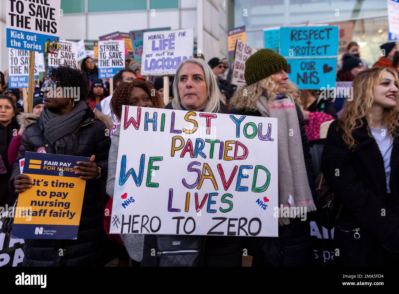 Protesters gathered outside the University College London calling for a pay rise for nurses and improvements in conditions. Partygate placard Stock Photo