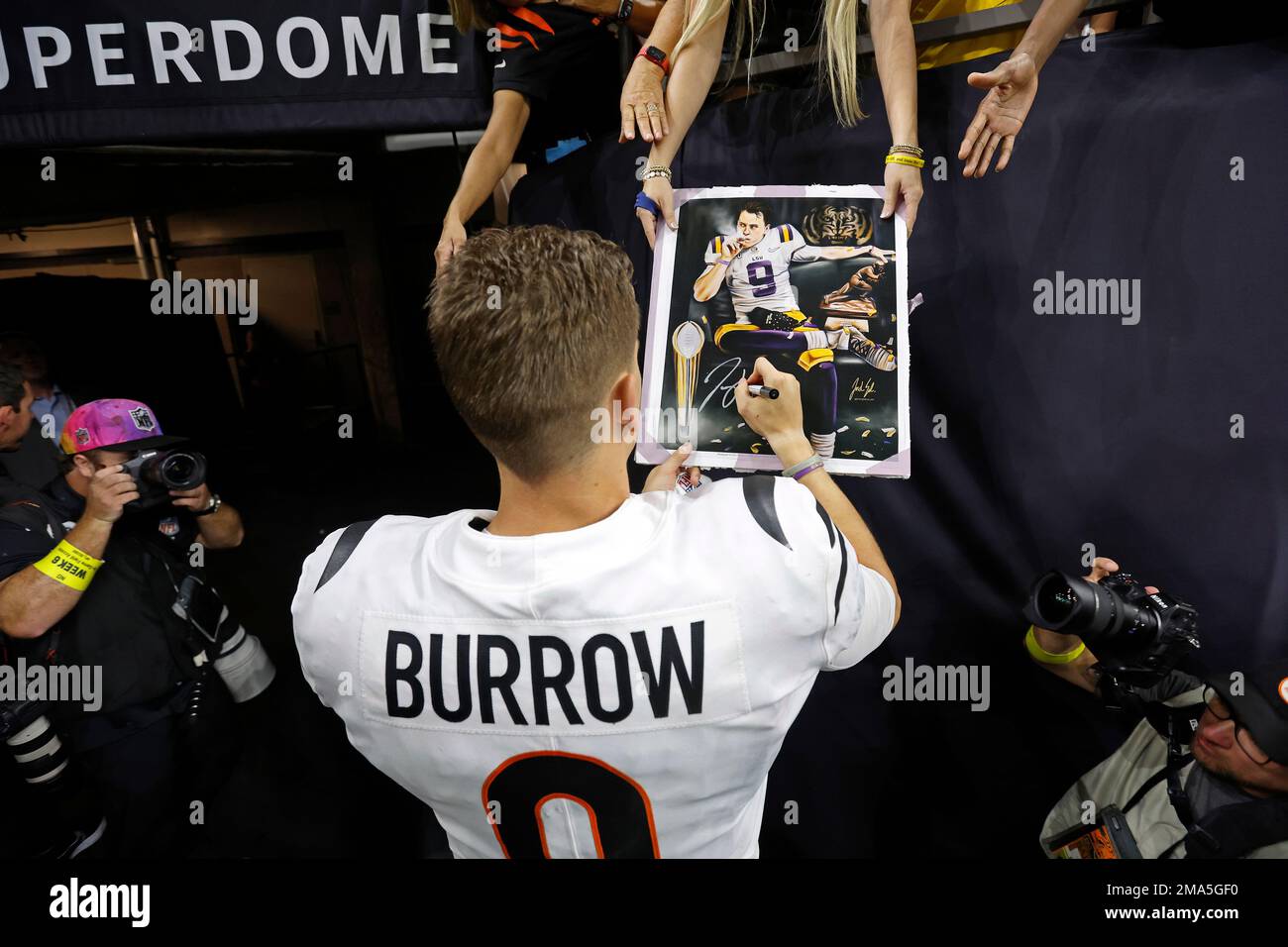 Cincinnati Bengals quarterback Joe Burrow (9) signs an autograph for fans  after an NFL football game against the New Orleans Saints, Sunday, Oct. 16,  2022, in New Orleans. (AP Photo/Tyler Kaufman Stock