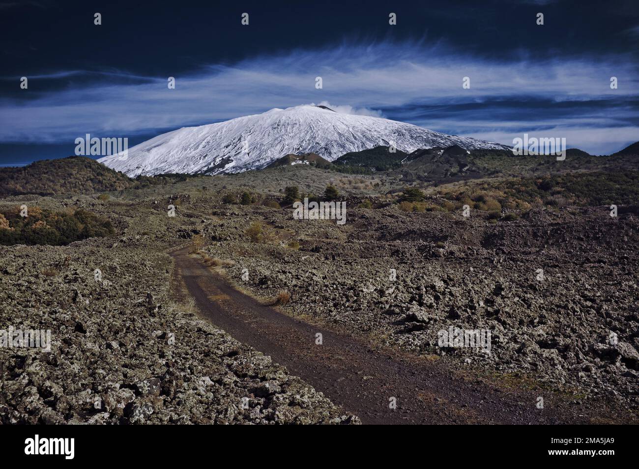 italian landscape of Mount Etna in National Park in Sicily, scenic path crosses volcano rocks, Italy Stock Photo