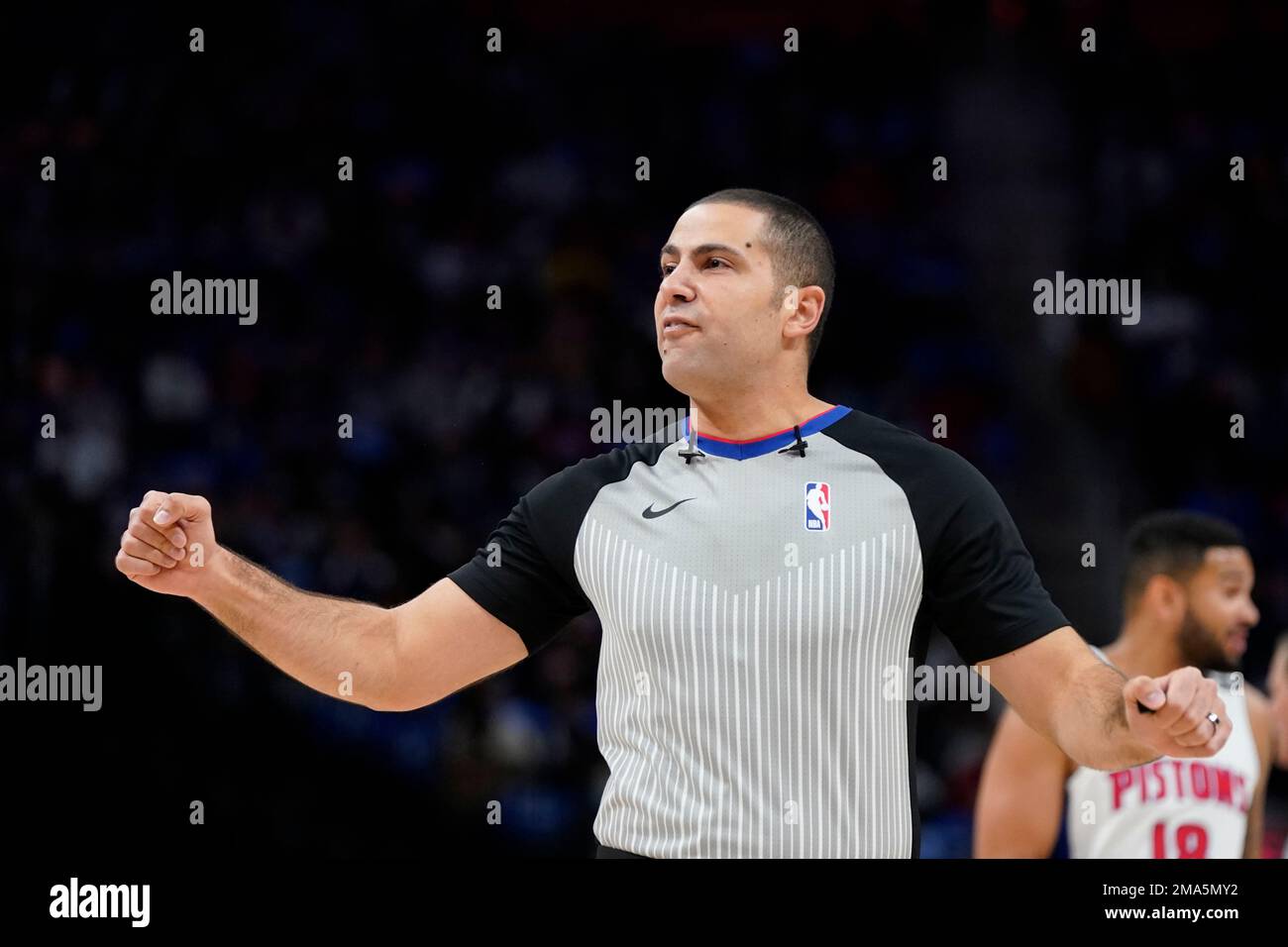 Referee Mousa Dagher signals during the first half of an NBA basketball
