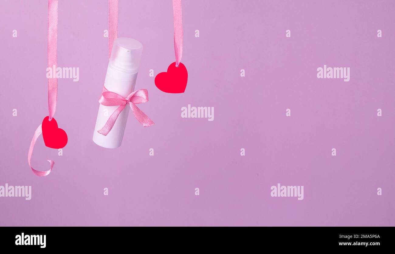 Flying red paper heart on pink background. Valentine's Day. Symbol of love. Copy space. Stock Photo