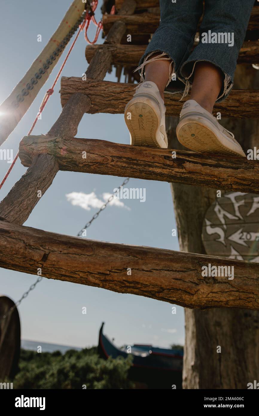 Girl climbing a wooden tower Stock Photo Alamy