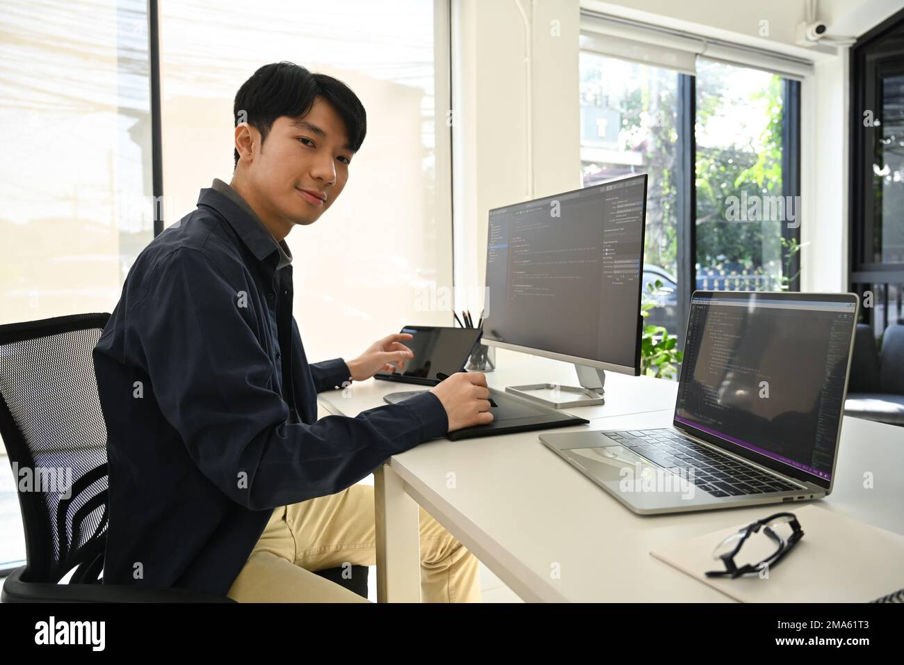IT specialist man checking debugging system on large curved monitor ...