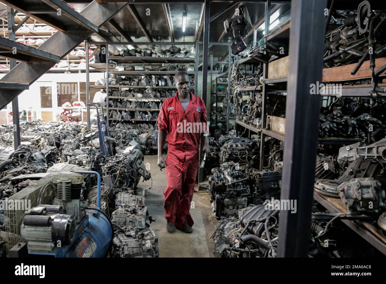 A worker looks for items at a secondhand car parts warehouse in the