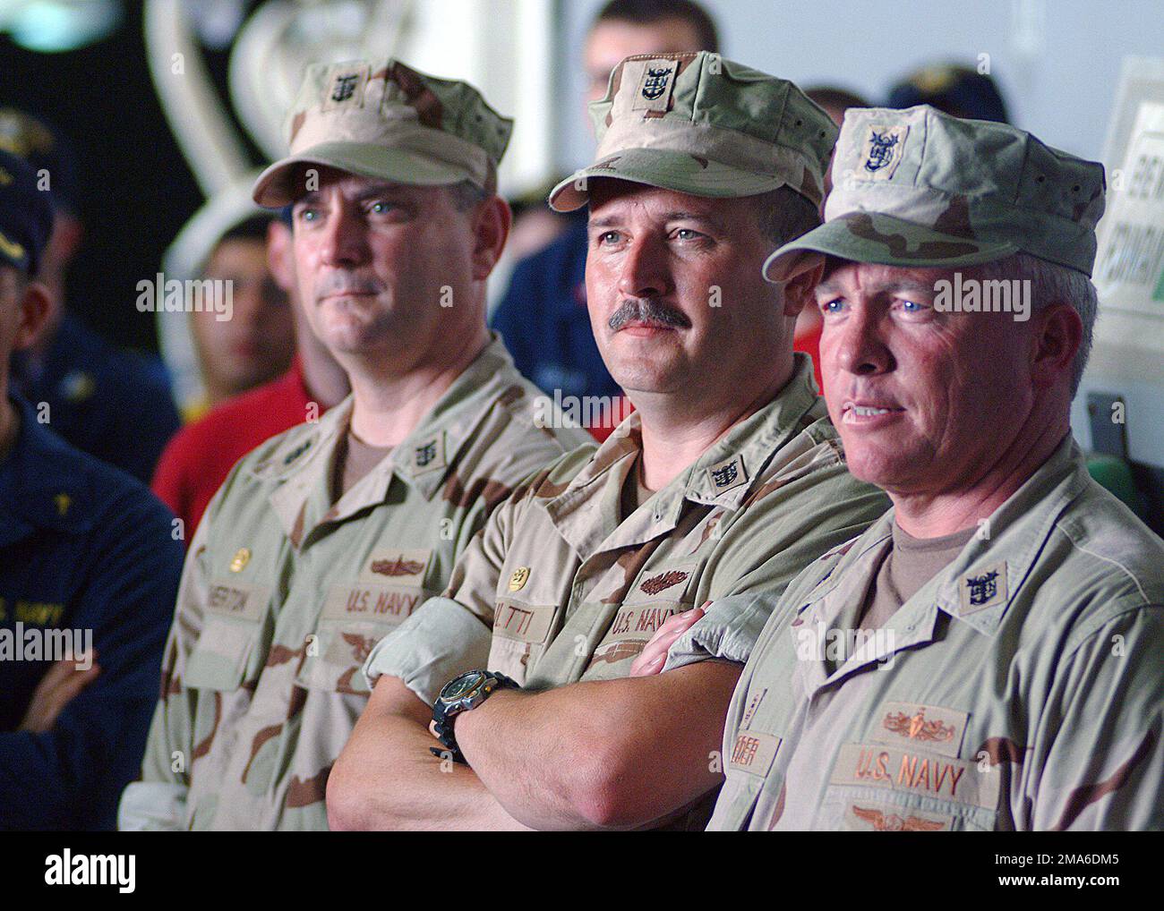 Three of the US Navys (USN) top Command MASTER Chiefs (CMC) observe an all hands call held aboard the Wasp Class: Amphibious Assault Ship, USS KEARSARGE (LHD 3), during their trip to the Persian Gulf focusing on Sailors issues in regards to training, equipment, and manning. Pictured left-to-right, MASTER CHIEF PETTY Officer (MCPO) Terry Etherton, 3rd Fleet CMC; MCPO Don Kultti, 2nd Fleet CMC and MCPO Kelly Schneider, 5th Fleet CMC. Base: USS Kearsarge (LHD 3) Stock Photo