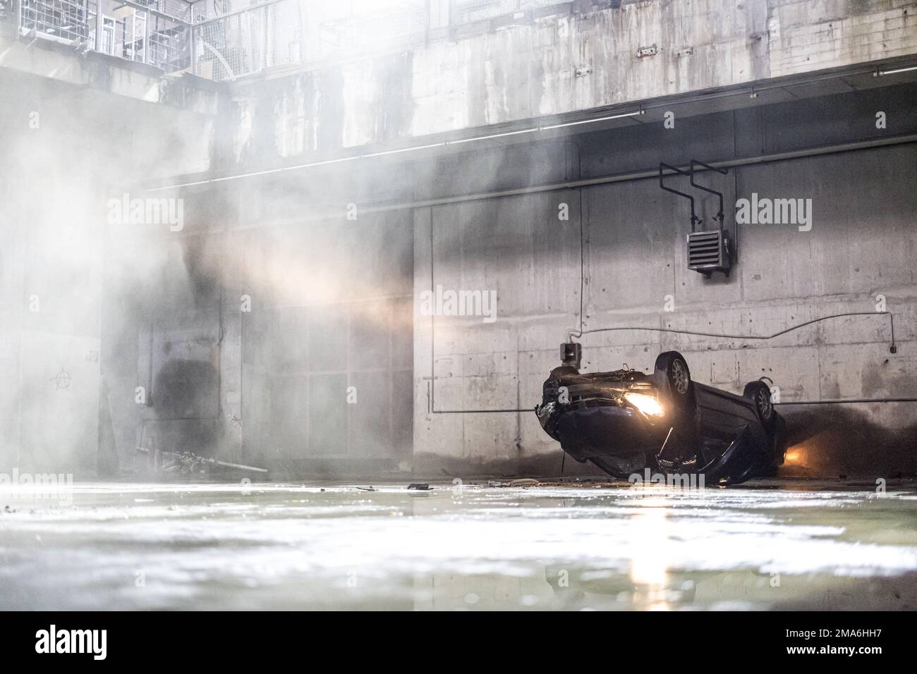 Munich, Germany. 05th May, 2022. A car crashes into a hole in a hall during a set date while filming the new Sky series 'Drift - Partners in crime'. The first five episodes of season 1 will start on February 24, 2023 on the Sky channel. Credit: Matthias Balk/dpa/Alamy Live News Stock Photo