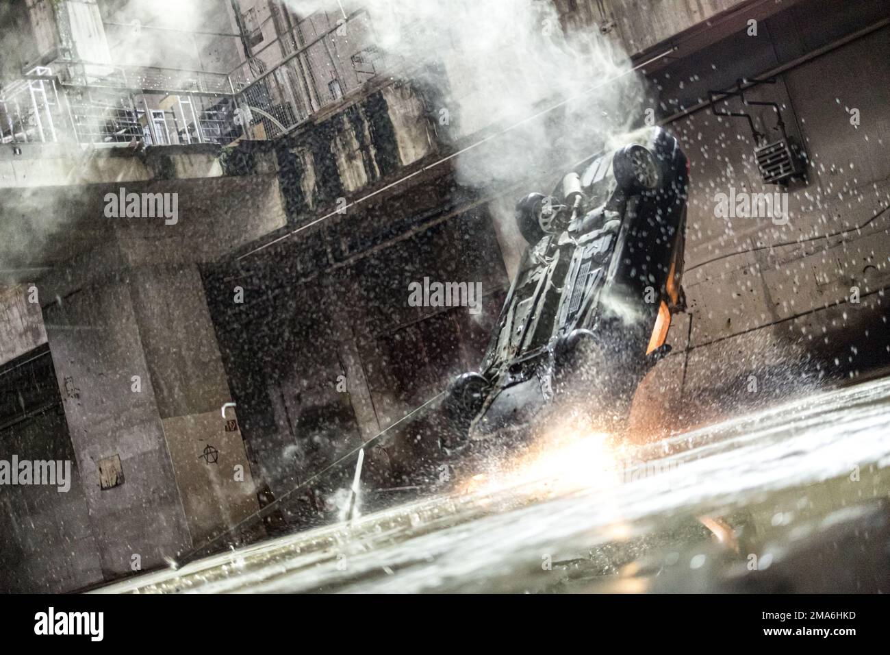 Munich, Germany. 05th May, 2022. A car crashes into a hole in a hall during a set date while filming the new Sky series 'Drift - Partners in crime'. The first five episodes of season 1 will start on February 24, 2023 on the Sky channel. Credit: Matthias Balk/dpa/Alamy Live News Stock Photo
