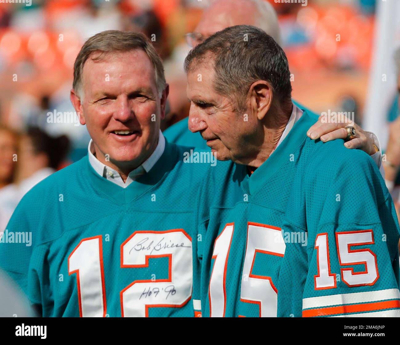 FILE - Former Miami Dolphins 1972 players Bob Griese (12) and Earl Morrall  (15) enjoy a half time celebration honoring the 1972 undefeated team at an  NFL football game against the Jacksonville