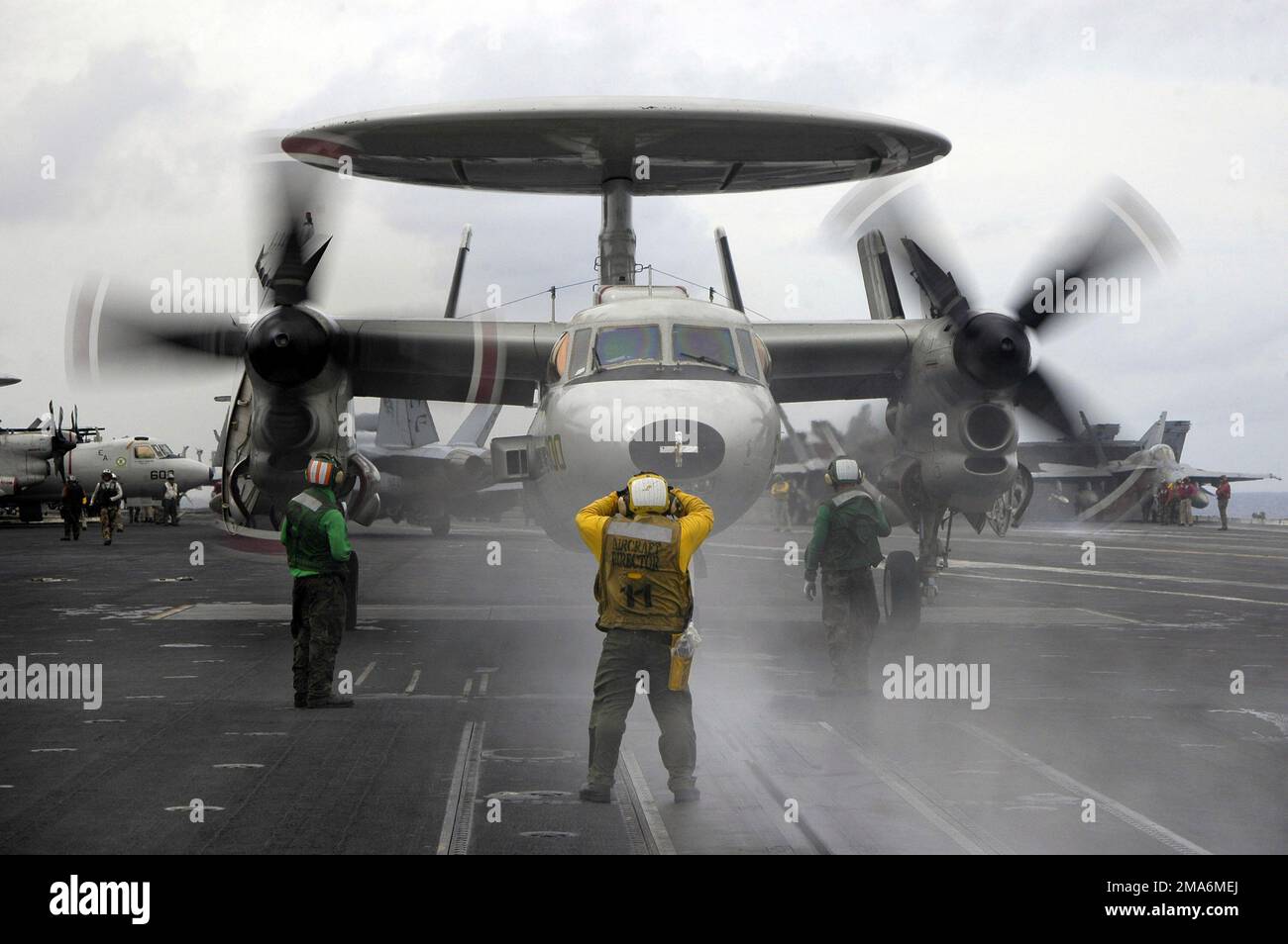 US Navy (USN) Sailors assigned to the Flight Deck Crew aboard the Aircraft Carrier, USS KITTY HAWK (CV 63), prepare to launch a USN E-2C Hawkeye, assigned to Carrier Airborne Early Warning Squadron One One Five (VAW-115), during the third annual Joint Air and Sea Exercise (JASEX), while conducting operation in the Western Pacific region off the coast of Yokosuka, Japan. Subject Operation/Series: JASEX Base: USS Kitty Hawk (CV 63) Country: Japan (JPN) Stock Photo