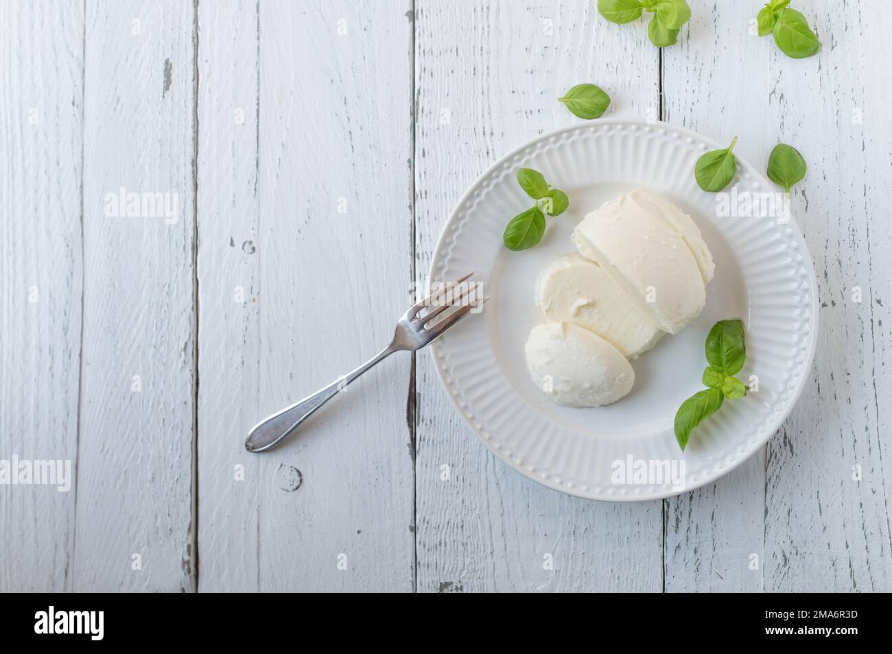 Mozzarella cheese on white background with space for text. Flat lay Stock Photo