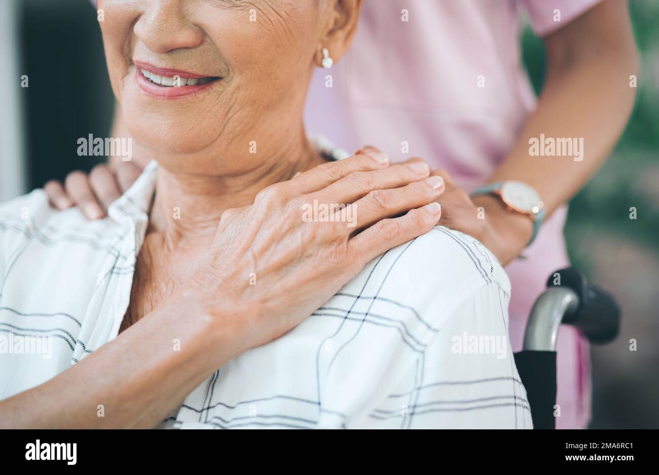 Hold on, for all the sunshine of our past. a nurse caring for an older woman in a wheelchair. Stock Photo