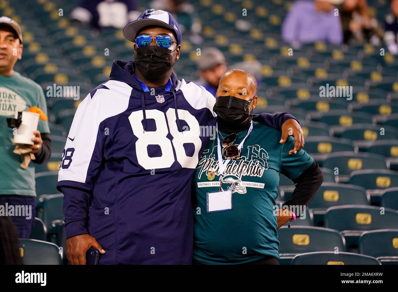 A Dallas Cowboys fan and a Philadelphia Eagles fan pose for a photo before  an NFL football game between the Eagles and Cowboys on Sunday, Oct. 16, 2022,  in Philadelphia. (AP Photo/Matt