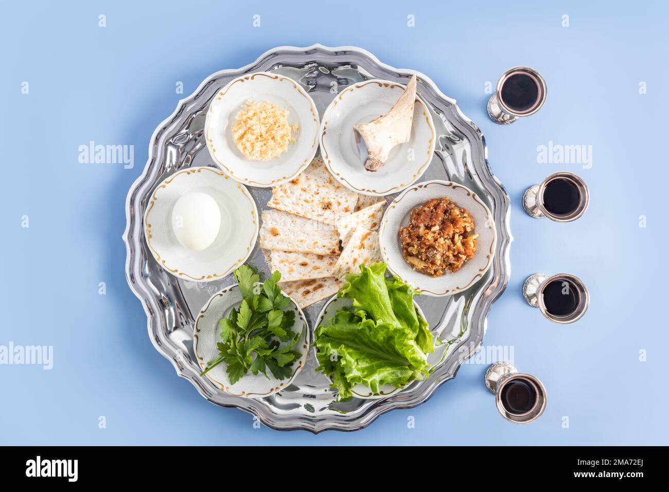 a pesach plate with traditional symbols of the Jewish Passover and four