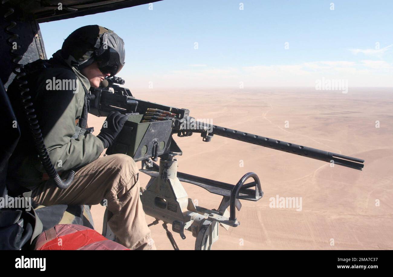 US Marine Corps (USMC) STAFF Sergeant (SSGT) Dan Jamison, Crewchief, Marine Light Attack Squadron 369 (HML/A-369), Marine Corps Base (MCB) Camp Pendleton, California (CA), checks out the GAU-16/A Cal. 50 machine gun onboard his USMC UH-1N Huey helicopter. The Huey and crew will provide close air support for coalition forces engaging insurgents in the city of Ubadyi, Iraq, during Operation Steel Curtain under Operation IRAQI FREEDOM. Base: Ubadyi State: Al Anbar Country: Iraq (IRQ) Stock Photo