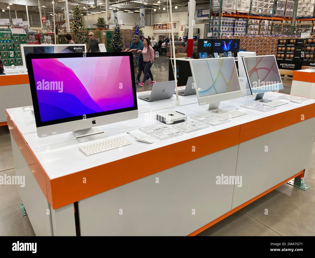 Shoppers pass by a display of computers in a Costco warehouse Friday ...