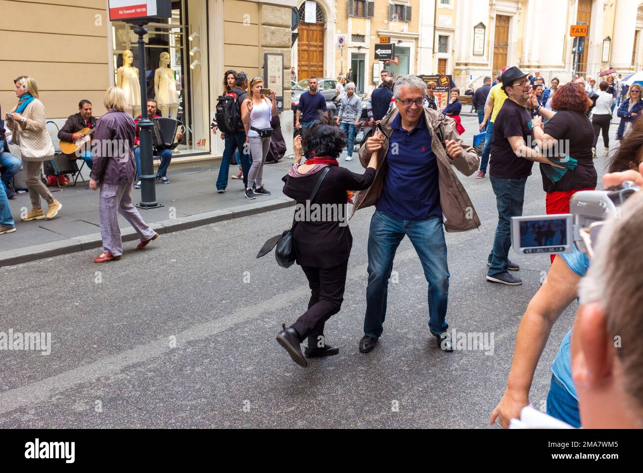 People in Rome the Italian capital, dancing in the street Stock Photo