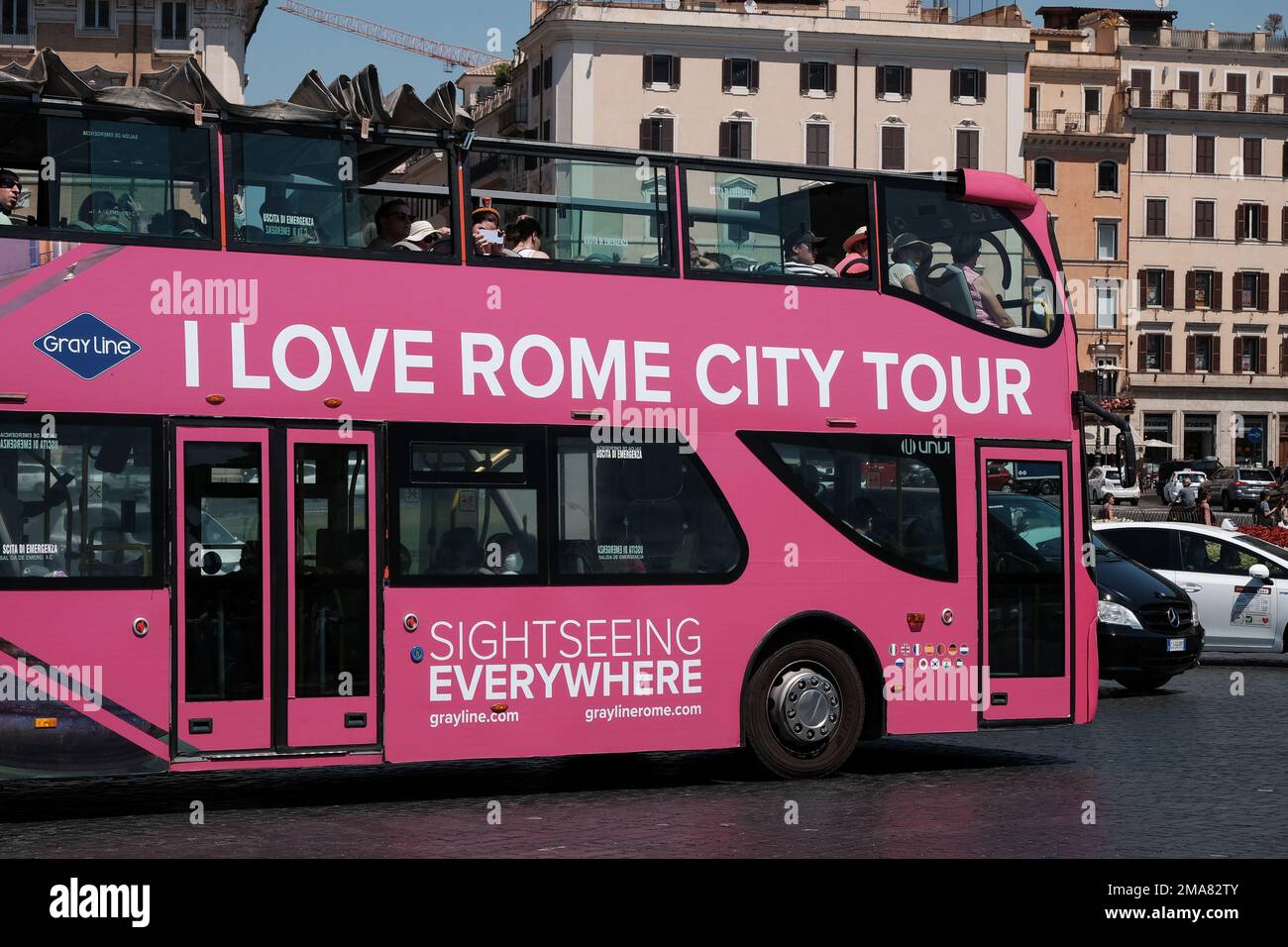 I love Rome city tour bus with passengers looking from windows at Vittorio Emmanuele monument. Stock Photo
