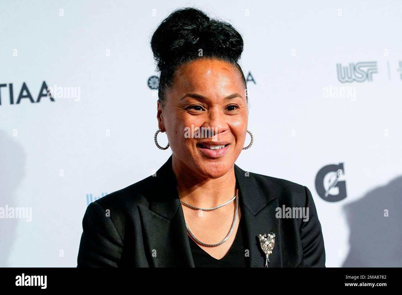 Dawn Staley poses for photos on the red carpet at the Women's Sports