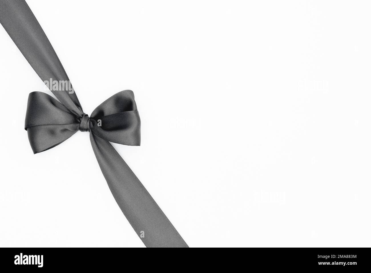 Satin ribbon bow for gift pack in grey color, isolated on white ...