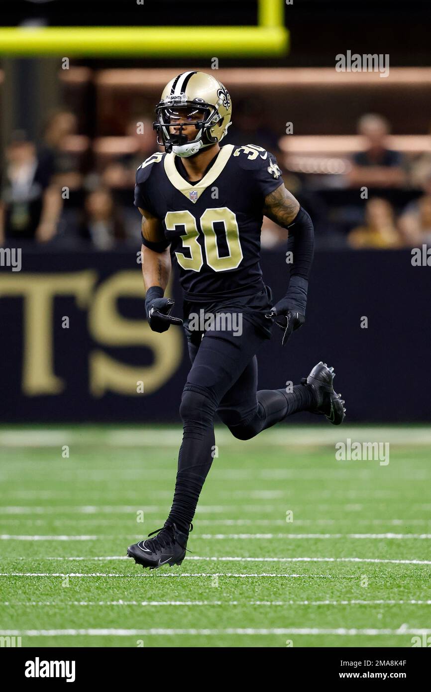 New Orleans, Louisiana, December 18, 2022. New Orleans Saints safety Justin  Evans (30) forces Atlanta Falcons wide receiver Drake London (5) into  fumbling the ball on a game-saving fourth down play late