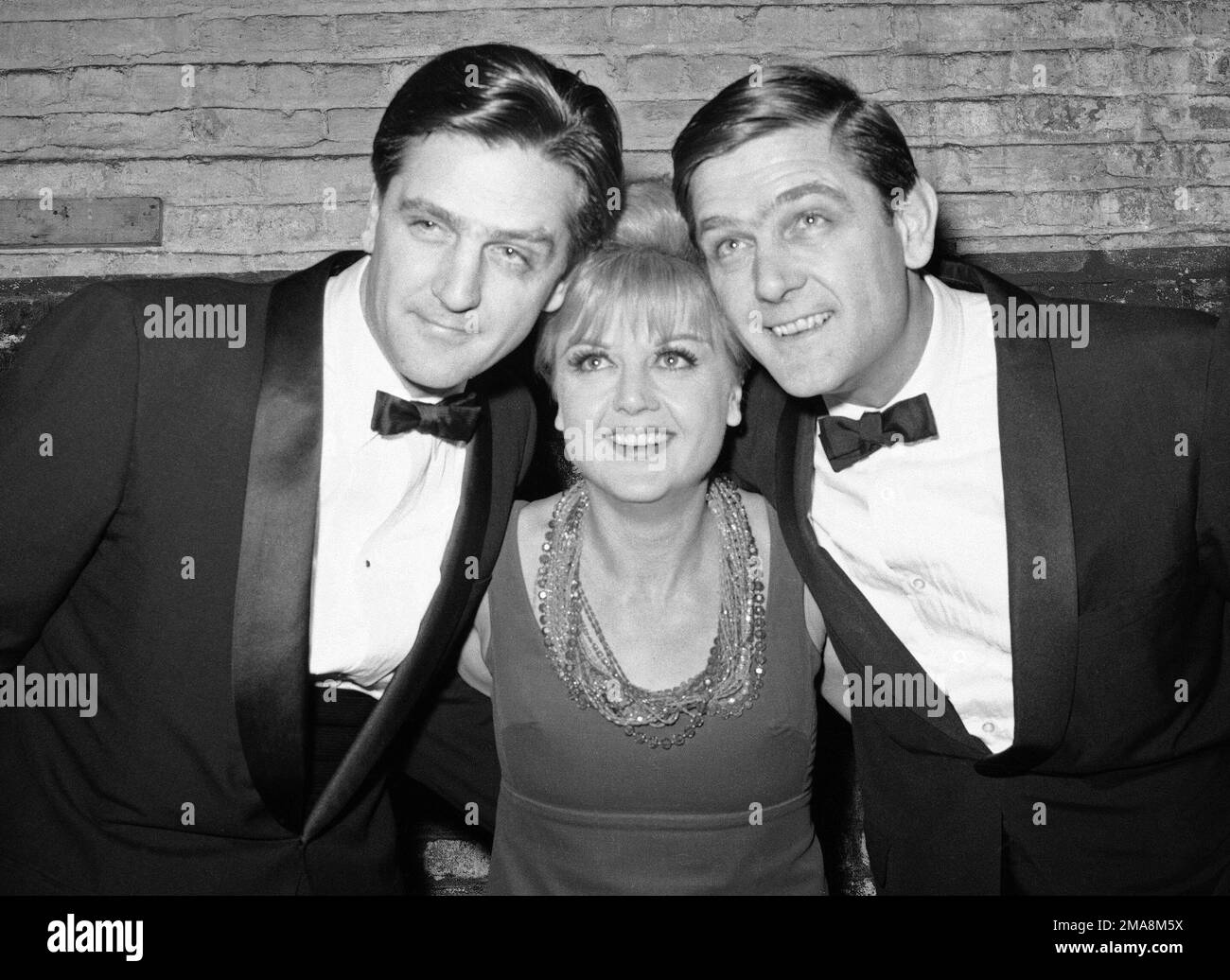 FILE - Angela Lansbury poses with her twin brothers Edgar, left, and