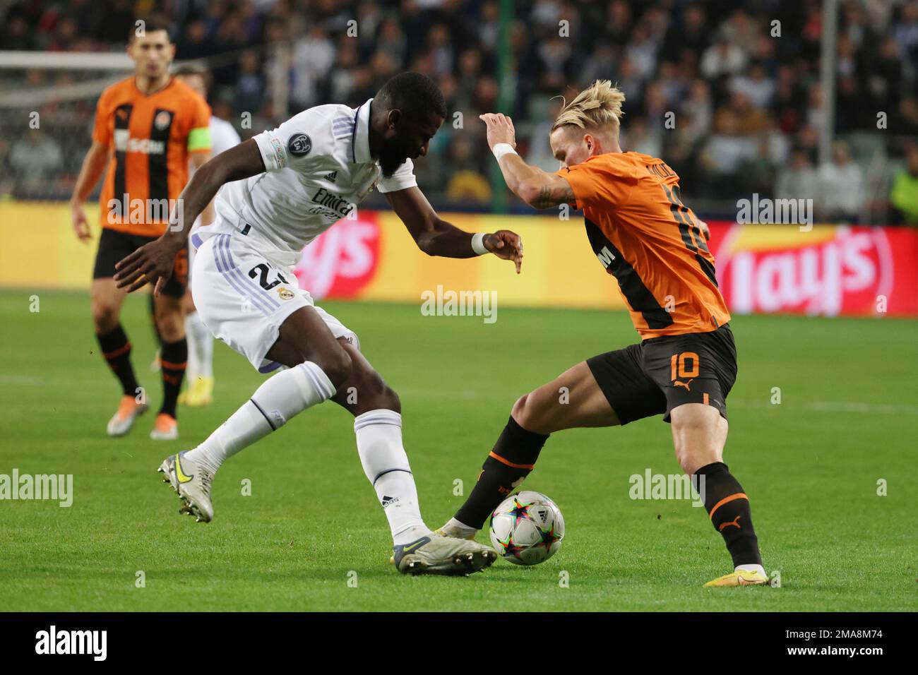 Shakhtar's Mykhaylo Mudryk, right, and Real Madrid's Antonio Rudiger  challenge for the ball during the Champions League group F soccer match  between Shakhtar Donetsk and Real Madrid at Polish Army Stadium stadium