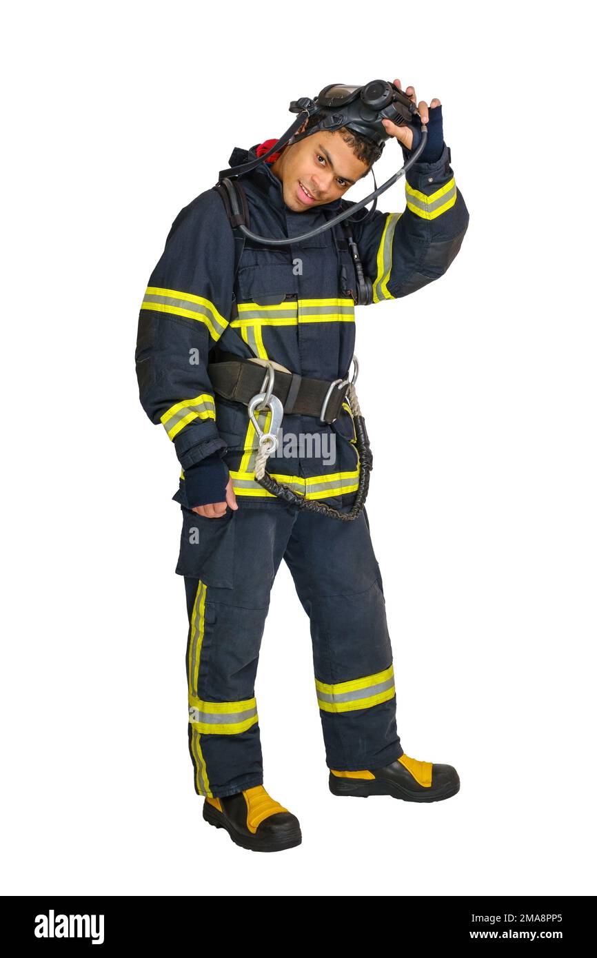 Fireman in uniform and with air breathing apparatus takes off protective mask Stock Photo