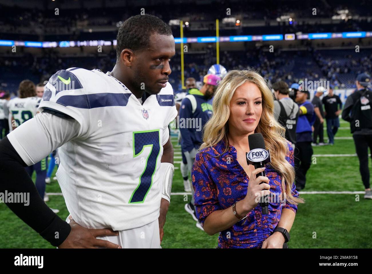 Fox Sports anchors conduct an interview after an NFL football game