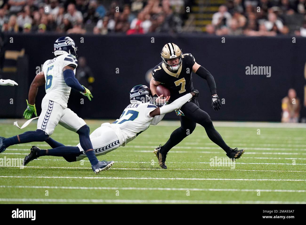 New Orleans Saints tight end Taysom Hill (7) carries for a first down  against Seattle Seahawks cornerback Tariq Woolen (27) during an NFL  football game in New Orleans, Sunday, Oct. 9, 2022.