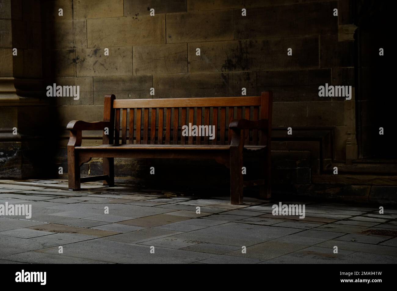 An Empty Bench An empty bench near the entrance of a building Stock Photo - Alamy