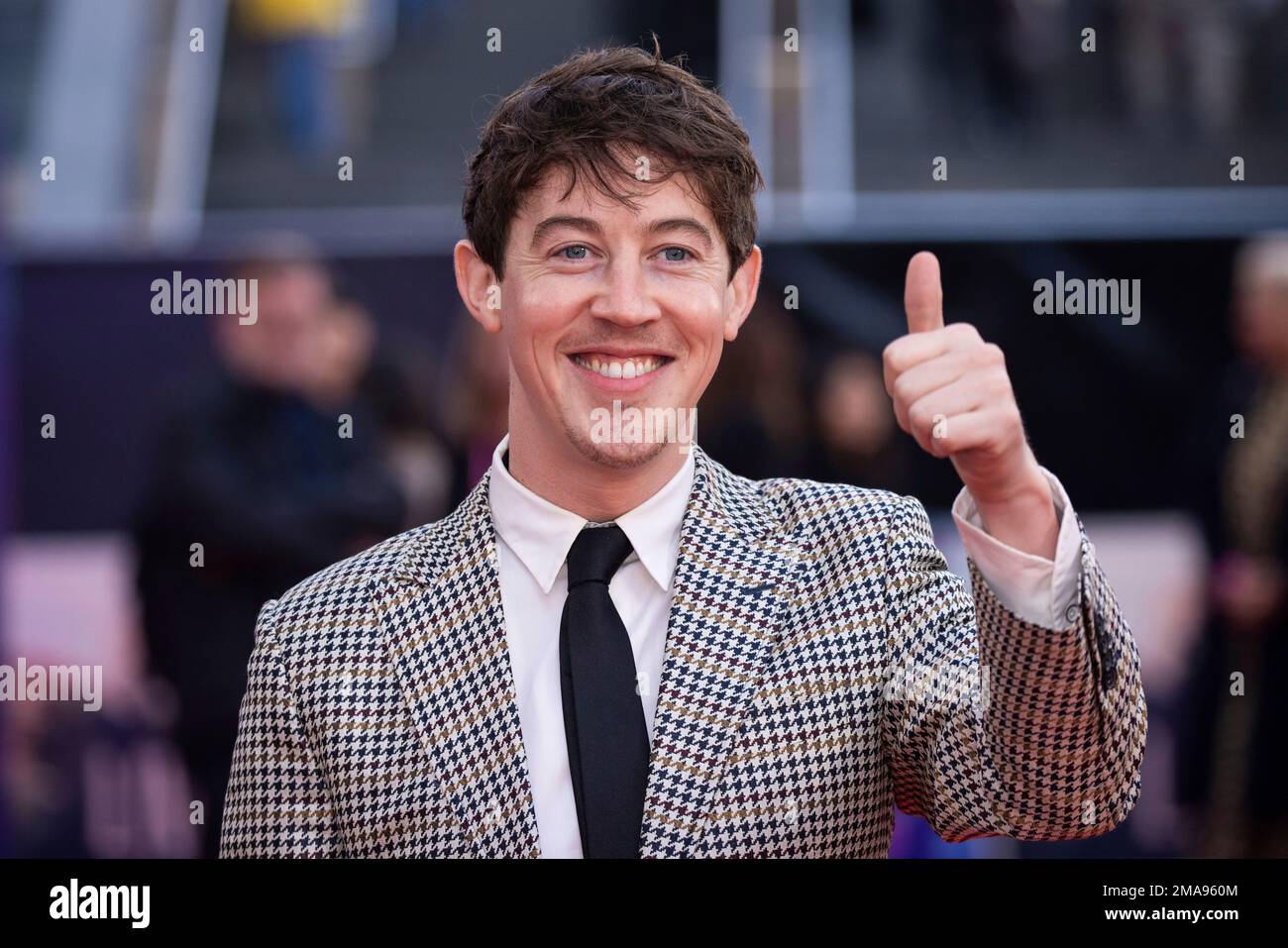 Alex Sharp poses for photographers upon arrival for the premiere of the