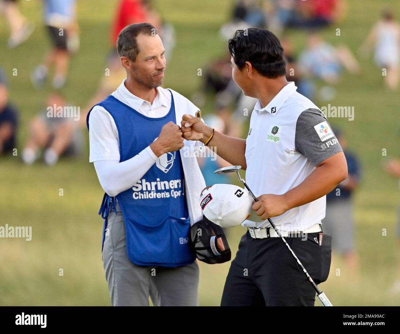Tom Kim, of South Korea, right, fist bumps his caddy after winning the ...