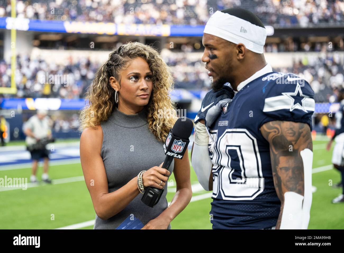 NFL Network reporter Kayla Burton, left, interviews Dallas Cowboys running  back Tony Pollard (20) after an NFL football game between the Los Angeles  Rams and the Dallas Cowboys Sunday, Oct. 9, 2022,